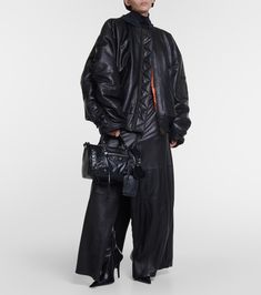 Find BALENCIAGA Oversized Leather Bomber Jacket on Editorialist. Made in Italy. Trim: 100% cotton. Pocket lining: 100% cotton. Pockets: flap pockets, snap-buttoned pockets. Care instructions: specialist clean. Lining: fully lined, 100% cupro. Contains non-textile parts of animal origin. Material: 100% leather. Closure: zipped front. Hood. Black Balenciaga, Balenciaga Women, Leather Jacket With Hood, Oversized Denim Jacket, Design Aesthetic, Jacket Brands, Leather Jackets Women, Outerwear Women, Outerwear Jackets