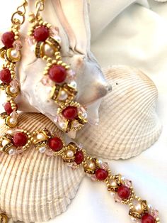 a red beaded bracelet on a shell