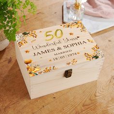 a personalized wooden box with flowers on it