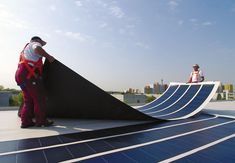 two men are working on a solar panel that looks like a skateboard ramp and ramps