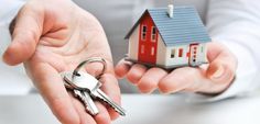 two hands holding keys to a small house