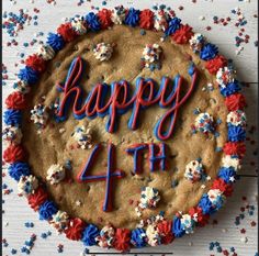 a fourth birthday cake with red, white and blue sprinkles on it