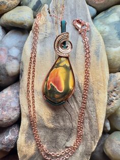 Cherry Creek jasper with copper, gold, and teal wire wrap Comes with 18" sterling silver plated chain shown in photos.  Pendant measures  1-7/8" x  11/16" Cherry Creek Jasper, Red Creek Jasper, Jasper Pendant, Metal Work, Cherry Red, Wire Wrap, Metal Jewelry, Jewelry Ideas, Pendant Necklaces