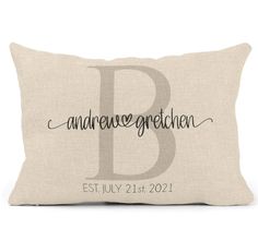 a pillow with the letter b on it, and an embroidered monogrammed initial