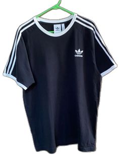 Casual Black T-shirt With Three Stripes, Black Relaxed Fit T-shirt With Three Stripes, Basic Adidas T-shirt With Three Stripes, Adidas Basic T-shirt With Three Stripes, Black Cotton T-shirt With Three Stripes, Classic Adidas Cotton Tops, Black T-shirt With Three Stripes, Sporty Adidas Cotton Shirt, Adidas Sporty Cotton Shirt