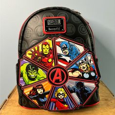 New With Tags Loungefly Marvel Avengers 60th Anniversary Glow In The Dark Mini-Backpack From Marvel, This Mini Backpack This Loungefly Backpack Is Made Of Vegan Leather (Polyurethane), Has A Front Zipper Compartment, Side Pockets, And Adjustable Back Straps. Inside, The Backpack Continues The Theme With Unique, Coordinating Lining Themed Black Backpack For Everyday Use, Black Retro Travel Backpack, Black Bag For Daily Use, Loungefly Backpack, Loungefly Bag, 60th Anniversary, Mini Backpack, Back Strap, Marvel Avengers