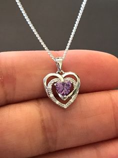 "Sterling Silver Amethyst CZ Heart Necklace Metal: All components are made from solid .925 Sterling Silver Stone: Cubic Zirconia Measurement: pendant is 17mm (0.67\")long including bail and 12mm (0.47\") wide Choose Chain Length Please feel free to Convo me with any questions before purchasing. Please view policy before purchasing You can find other CZ and Birthstone Jewelry in my shop here https://www.etsy.com/shop/LinksAndStones?ref=seller-platform-mcnav&section_id=24399452 Thank You For V Purple Heart-cut Sterling Silver Necklace, Purple Heart Cut Sterling Silver Necklace, Sterling Silver Purple Heart Pendant Necklace, Purple Sterling Silver Heart Pendant Necklace, Purple Sterling Silver Necklaces For Valentine's Day, Purple Sterling Silver Heart Cut Necklace, Amethyst Birthstone Heart Pendant Jewelry, Purple Heart Necklace For Valentine's Day Anniversary, Anniversary Amethyst Heart Necklace