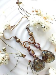 Beautiful hand wired rustic earrings! Blue Czech glass drops and copper rainbow beads come together for one unique pair of earrings. Bronze Wire Wrapped Czech Glass Earrings, Bronze Wire Wrapped Earrings With Czech Glass, Handmade Bronze Czech Glass Earrings, Bohemian Iridescent Jewelry With Ear Wire, Nickel-free Glass Bohemian Earrings, Bohemian Glass Beaded Earrings With Ear Wire, Bohemian Beaded Earrings With Glass Ear Wire, Iridescent Wire Wrapped Drop Earrings, Bohemian Teardrop Glass Jewelry