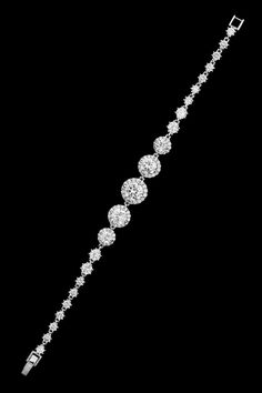 Pave Circles CZ Wedding BraceletThis  brilliant cz wedding bracelet has a unique design and is decorated with glistening AAA quality cz crystals. This bracelet is plated in silver rhodium. This accessory will be the perfect finishing touch for your wedding or special occasion ensemble.Size: about 7.25 Long.Color: Silver.Style: b427.Stunning!A matching jewelry set is available as dr427.Please allow 1 week for delivery.Shipping Policy.Return Policy. Dazzling Tennis Bracelet With Sparkling Stones For Wedding, Wedding Cubic Zirconia Diamond Bracelet With Handset Stones, Wedding Diamond Bracelet With Handset Cubic Zirconia Stones, Wedding Tennis Bracelet With Sparkling Stones, Wedding Tennis Bracelet With Sparkling Cubic Zirconia, White Gold Crystal Bracelets With Sparkling Stones, Anniversary Bracelet With Handset Cubic Zirconia Stones, Anniversary Bracelets With Handset Cubic Zirconia Stones, Dazzling Tennis Bracelet With Diamond Accents For Wedding