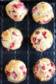 six strawberry muffins sitting on top of a grill