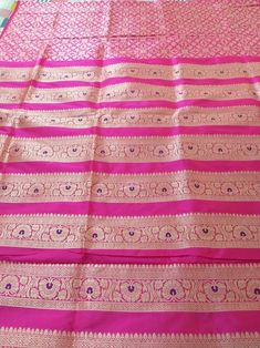 This Banarasi handloom pure silk lehenga is a perfect festive/wedding/occasional wear it enhanced with pink color motifs.  Occasion: party wear/wedding  Materials. Pure silk. Unstich lehenga  Fabric design - Banarasi  Meenakari.  Pattern: Floral/paisley/buti motifs.  Borders: yes  Border type: Zari  Zari type: golden zari  Fabric length with blouse and with dupatta.  Borders is 6.5 meters  Blouse: 0.85 Meters  No of kali: 18 Size of kali 42 inch  No of border in dupatta 9 Meenakari Raw Silk Choli For Saree, Festival Meenakari Raw Silk Choli, Meenakari Chanderi Lehenga For Festivals, Festival Chanderi Lehenga With Meenakari, Chanderi Lehenga With Meenakari For Festivals, Festive Banarasi Silk Lehenga With Zari Work, Semi-stitched Banarasi Silk Lehenga For Festivals, Festival Sharara In Raw Silk With Meenakari Detailing, Traditional Drape Raw Silk Lehenga With Meenakari Details