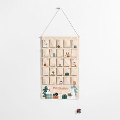 a white wall hanging with an animal themed calendar on it