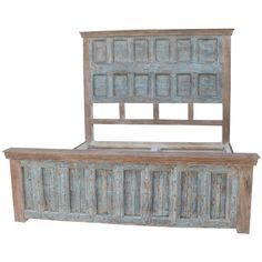 an old wooden bed frame with blue paint on the headboard and foot board, against a white background