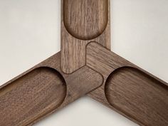 three pieces of wood are arranged in the shape of an x on a white background