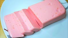 three pieces of pink soap sitting on top of a white plate