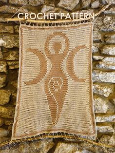 a crochet pattern hanging on a stone wall with the words crochet written below it