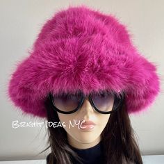 "Fun, stylish and warm Fluffy Fuzzy Luxury Faux Fur Vegan Bucket Hat that makes the perfect accessory. Vegan Super comfy 23\" circumference Quilted Lining Bright Pink Adjustable drawstring To view the rest of our collection, please visit: brightideasnyc.com" Pink Brimmed Bucket Hat For Winter, Trendy Faux Fur Winter Hat, Trendy Winter Faux Fur Hat, Pink Wide Brim Mini Hat For Winter, Trendy Mini Bucket Hat For Winter, Trendy Winter Mini Bucket Hat, Fluffy Faux Fur Hat For Cold Weather, Pink Winter Bucket Hat With Short Brim, Fluffy Faux Fur Hat For Fall