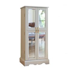 a tall white cabinet with mirrored doors