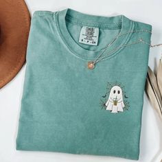 If you love Halloween & nostalgia - you NEED this Embroidered Ghost with Coffee Comfort Colors T-Shirt! This is perfect for the fall season- would also make a great gift for someone that is obsessed with all things Halloween/Fall. * PRODUCT DETAILS * ✺ 100% Cotton ✺ Wash and dry normally (on cool for best results) ✺ Due to different monitor screens, colors may vary ✺ * SIZING * ✺ FOR AN OVERSIZED FIT, SELECT TWO OR THREE SIZES UP FROM YOUR NORMAL SIZE ✺ ✺ Sizing is unisex ✺ Size guide: Please co Ghost With Coffee, Halloween Nostalgia, Embroidered Ghost, Embroidered Halloween, T-shirt Broderie, Comfort Colors Tshirt, Love Halloween, Halloween Fall, Halloween Tees