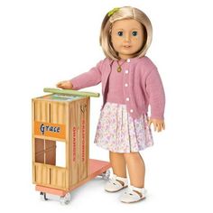 a doll standing next to a wooden crate