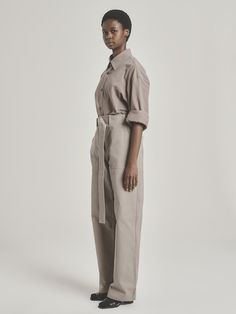 Take off-duty dressing to the next level with UNI FORM’s Utility Pants. They’re made in South Africa from tobacco-hued cotton and have a comfortable, relaxed fit that makes them extra versatile. Designed to sit high on the waist, they’re finished with roomy patch pockets and an adjustable belt for a flattering touch. Make sure to tuck your shirt or blouse in. - High rise, concealed zip fly, adjustable belt, patch pockets, full length - Cotton - Crafted locally with natural fibers - Each piece is Neutral Cotton Wide Leg Pants For Work, Casual Cotton Pants With Belted Cuffs, Cotton Work Pants With Belted Cuffs, Cotton Workwear Pants With Belted Cuffs, Cotton Wide Leg Pants For Daywear In Fall, Cotton Wide Leg Pants For Fall Daywear, Brown Cotton Wide Leg Workwear Pants, Brown Cotton Wide Leg Pants For Work, Tuck Your Shirt