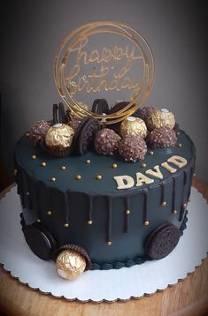 a birthday cake with cookies and chocolates on top