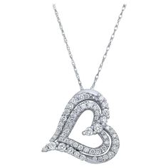 This stunning natural diamond heart pendant showcases prong set white sparkling round cut diamonds in a double heart-shaped cut out design. Crafted in 14K white gold. Total diamond weight: 0.50 carat. Each diamond is of VS-SI clarity and H-I color. This piece would make the perfect anniversary, birthday, or holiday gift. Pendant size: 17mm x 18mm. Chain length: 18 inches. Total necklace weight: 3.26 gms. Comes with a presentable gift box and an appraisal card. Diamond Heart Pendant Necklace, Heart Pendant Diamond, Double Heart, Cut Out Design, Diamond Heart, Heart Pendant Necklace, Round Cut Diamond, Chain Length, Prong Setting