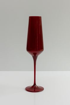 a red wine glass sitting on top of a table