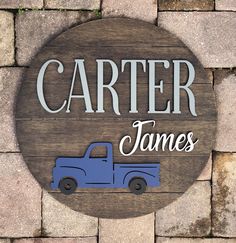 a wooden sign that says,'center james'with a blue truck on it