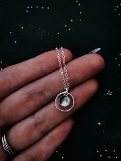 "This delicate pendant is positively darling. This petite necklace is available in sterling silver or 14k gold and is personalized with the moon phase that had been in the sky during an important occasion in your life! Was it the day you were born? Married? Had children? A life-changing experience? Whatever the moment, there was a phase of our moon shining down on it. This itty bitty moon hangs in the middle of a delicate gold or silver halo. To order, please provide the following information in Dainty Moon Phase Necklaces For Wedding, Delicate Moon Phase Pendant Jewelry, White Gold Moon Charm Necklace For Wedding, Celestial Silver Jewelry For Gifts, Dainty Moon Phase Necklace For Wedding, Celestial Style Silver Jewelry For Gifts, White Gold Moon Phase Necklace For Wedding, White Gold Necklace With Moon Charm For Weddings, White Gold Wedding Jewelry With Moon Charm