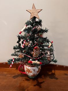 a small christmas tree decorated with gingerbreads and candy canes