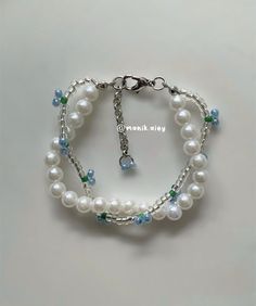 a bracelet with white pearls and blue beads