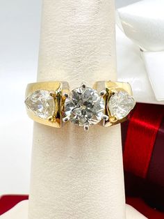 Beautiful 14K Yellow Gold Diamond 2.25ct Ring Size 5.5 A perfect gift for your loved one for any special occasion or holiday! Total Ring Weight: 7.42g Ring Length: 23.40mm Ring Width: 19.90mm Gemstone: Diamond Total Diamond: 2.25ct Center Diamond approximately 1.25ct Side Diamonds approximately 1.00ct Item will be placed into a gift box. * Gia Certified Pear-shaped Ring For Anniversary, Gia Certified Pear-shaped Anniversary Rings, Pear-shaped Gia Certified Rings For Anniversary, Vvs Clarity Pear-shaped Diamond Ring For Anniversary, Trillion Cut Diamond Ring For Anniversary, White Diamond Ring Gia Certified Gift, Gia Certified Trillion Cut Diamond Ring As Gift, Gia Certified White Diamond Ring Gift, Gia Certified Heart Cut Diamond Anniversary Ring