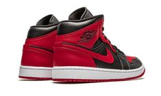 The Air Jordan 1 Mid “Banned 2020” is a colorway of Michael Jordan’s first signature shoe that draws comparisons to the design of the Nike Air Ship that Jordan was prohibited from wearing in the NBA in 1985.  Appearing on the alternate mid-top height of the Jordan 1, the “Banned” matches the black and red color block of the Air Ship he played in and the original Jordan 1 “Bred” colorway.  The design features red leather on the perforated toe, eyelets, collar, and heel.  Contrasting black leather Nike Air Ship, Jordan 1 Banned, Jordan 1 Mid Banned, High Top Jordans, Air Ship, Original Air Jordans, Nike Air Jordan 1 Mid, Jumpman Logo, Black Wings