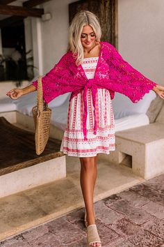 - Set sail in this beautiful crochet tie top! - Hot pink colored crochet material - Loose, three-quarter length sleeves - Open draped silhouette that ends in an uneven hemline perfect for front tie closure Pink Lace Crochet Dress For Summer, Pink Crochet Dress As Beach Cover-up For Spring, Pink Bohemian Crochet Dress, Pink Crochet Top For Vacation, Pink Crochet Top For Spring Vacation, Spring Vacation Pink Crochet Top, Pink Lace Crochet Top For Beach, Pink Crochet Top With Crochet Trim For Vacation, Pink Lace Crochet Top For The Beach