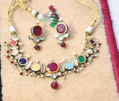 Handmade item Materials: Brass Gemstone: Ruby Jewelry type: Earrings, Necklace Style: Art deco Can be personalized: Yes Round Kundan Necklace For Marriage And Festivals, Kundan Necklace For Marriage And Festivals, Traditional Kundan Necklace For Marriage, Multicolor Bridal Necklace With Latkans For Festive Occasions, Multicolor Jewelry For Marriage And Festivals, Bollywood Style Multicolor Round Jewelry Sets, Multicolor Kundan Jewelry Sets With Round Shape, Multicolor Round Jewelry Sets For Diwali, Multicolor Meenakari Jewelry For Marriage