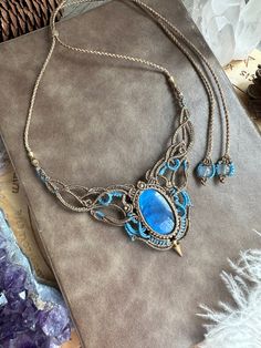 a blue necklace sitting on top of a table