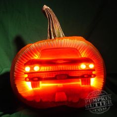 a pumpkin shaped like a car with its lights on