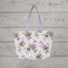 "Beautiful spring/summer purple and lavender floral print tote bag is perfect for women on the go who love the spring purple hues floral look! Tote bag can be folded easily into a suitcase for added convenience. Tote can be carried or wore on the shoulder. This multi-faceted bag can be used as a purse, to carry work supplies, used as a carry-on, travel bag, shopping, or for any event. Make-up bags, glasses, cell phone, and many other personal items can be placed in it securely. Tote would also m Purple Rectangular Bag For Summer, Spring Travel Purple Shoulder Bag, Casual Purple Shoulder Bag For Spring, Purple Beach Bag For Daily Summer Use, Purple Beach Bag For Daily Use In Summer, Purple Tote Bag For Spring, Spring Purple Tote Bag, Purple Summer Bags For Daily Use, Summer Purple Bags For Daily Use