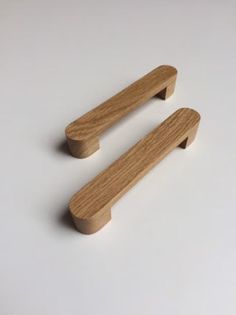 two wooden handles on a white surface