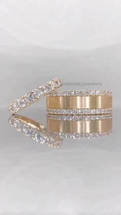 two gold wedding bands with diamonds on them