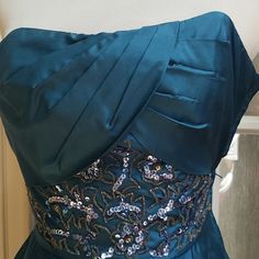 Nwt A Stunning, Vintage Betsey Johnson Dress With Form Fitting, Pleated Bodice. It Is A Teal Colored Silk Short, Strapless, Sequined Embroidered Detail At Waistline With A Pleating At Front Of Flared Skirt In Size 2 - Dress Shell Is 100% Silk With Tulle Underlay (Lining 1 Is 100% Acetate) And Lining 2 Is 100% Nylon. Zipper On Side, Measurements: Bust = 30" Waist = 23" Embroidered Satin Party Gown, Blue Dress With Fitted Bodice For Festive Season, Blue Embroidered Evening Dress For Party, Fitted Satin Dress For Festive Occasions, Embroidered Satin Evening Dresses, Elegant Blue Evening Dress For Festive Occasions, Silver Embroidered Dress For Festive Season, Festive Embroidered Dress For Prom, Silver Embroidered Festive Dress