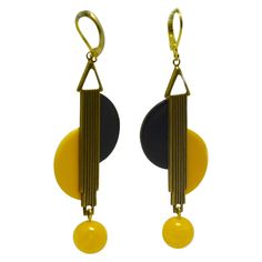 Beautiful piece of jewellery are these modernist pair of drop earrings. As one of the leading manufacturers of jewellery the European Art Deco produced in the 20's and 30's very innovative and individual pieces of jewellery, aesthetically characterised by the modernist designs. These earrings are made from Black and yellow Bakelite, with gold tone metal work ribbed to the centre. Very much in the style of Jakob Bengel. The mildest of tarnishing otherwise excellent condition. All our Jewellery and watches are sent out in complimentary gift boxes first class international delivery 2-3 days. Art Deco Drop Earrings, White Gold Drop Earrings, Jewellery Inspiration, Yellow Art, 1920s Art Deco, 1930s Art Deco, Ancient Jewelry, Modern Art Deco, Art Clay