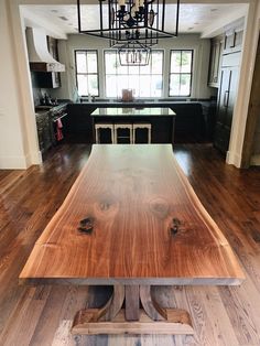 a large wooden table sitting in the middle of a kitchen