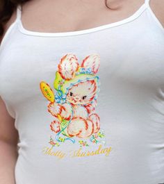 -Soft cotton white tank with slight stretch. High Quality vintage bunny graphic print that stretches with you. -comes pre-cropped, hits around hip length -Model is a size 6, wearing a size Medium, more sizes available in baby tees and unisex tees (xs-3xl), put in personalization section! -Design available on cropped raw hem white baby tee or unisex tee as well Fitted Graphic Print Cute Tank Top, Playful White Cotton Tank Top, Playful White Tank Top For Spring, Spring Retro Graphic Print Tank Top, Summer Cotton Tops With Bunny Design, Summer Cotton Top With Bunny Design, Vintage White Crop Top With Graphic Print, Cute Graphic Print Tank Top, White Vintage Tank Top For Spring