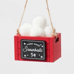 a red box with three snowballs hanging from it