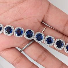 This exquisite bracelet features 6mm round sapphire gemstones surrounded by a halo of round natural earth mined diamonds. Perfect for any event, everyone will be drooling over your new luxury gemstone bracelet!! This Blue Sapphire bracelet also makes a lovely September birthstone gift for your loved ones! This bracelet is made with solid 14K Gold and natural Earth mined SI / G-H diamonds. Sapphire Tennis Bracelet, Round Diamond Halo, Blue Sapphire Bracelet, Bracelet With Diamonds, Designer Silver Jewellery, Round Sapphire, Jewelry Showcases, Sapphire Bracelet, Birthstone Gifts