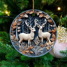 a christmas ornament with two deers on it