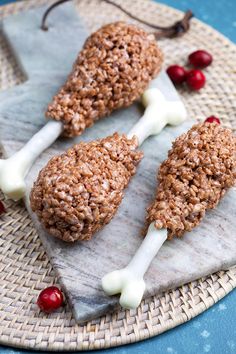 three pieces of food sitting on top of a plate with cherries in the background