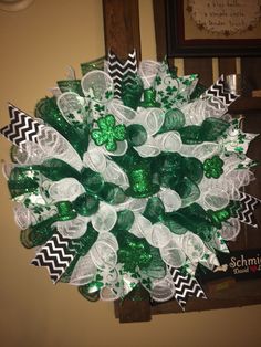 a green and white wreath with candy in it